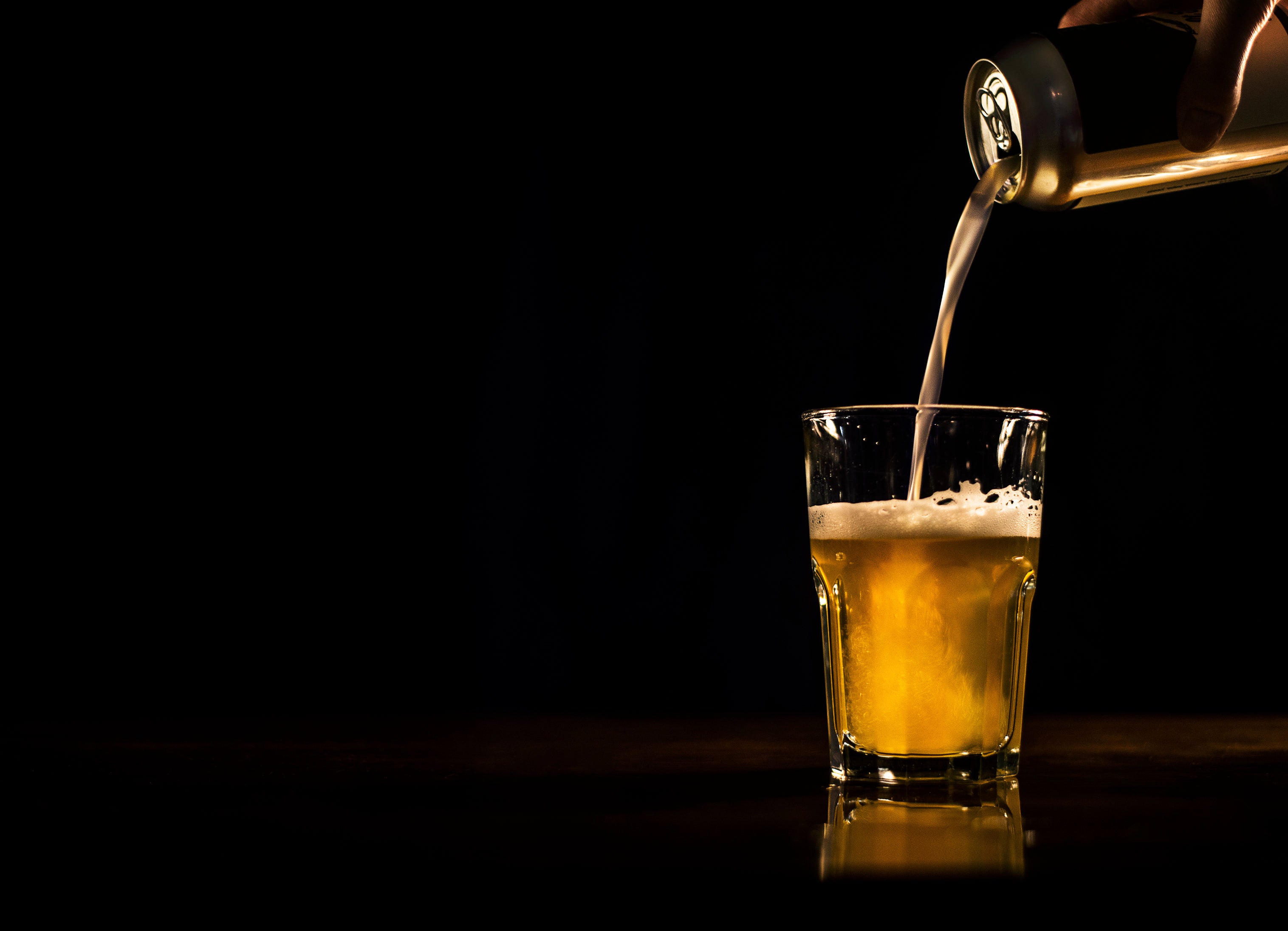 Beer pouring from can to glass